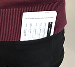 A pocket information guide peeks out of the back pocket of someones jeans.