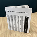 A folded but upright pocket information guide sits atop an office table. 