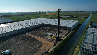 Photo shows an aerial view of our current greenhouse layout with construction in the center.