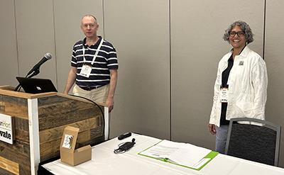 Dr. Erik Runkle pictured left behind a speakers podium next to Dr. Sonali Padhye.