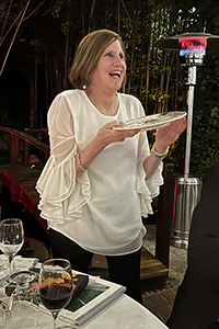 Anne Leventry smiles holding a commemorative plate.