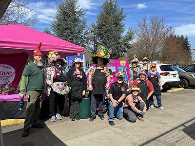 Group of people with crafted homemade garden-themed hats