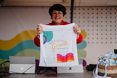 Woman holding a colorful tote bag