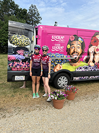 Two bike riders celebrating outdoors