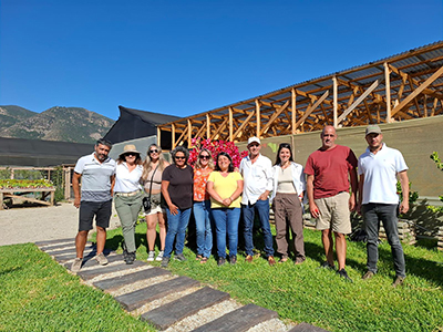 Group outside in front of a greenhouse