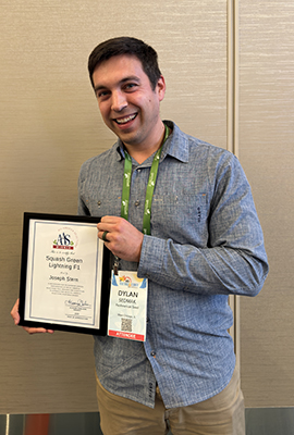 Man holding a framed award