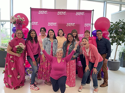 Group of people wearing pink and celebrating Wave Petunias