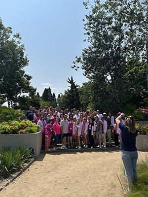 People waving for a photo in a garden